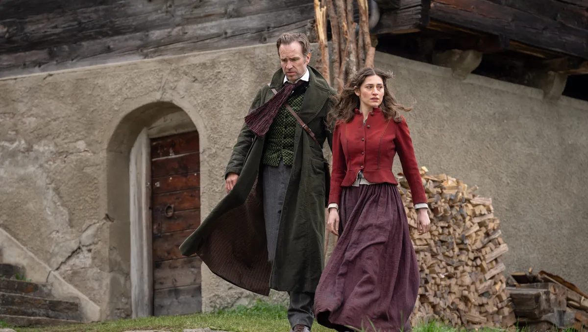 Rafe Spall with a thoughtful expression, possibly in character as Sherlock Holmes.