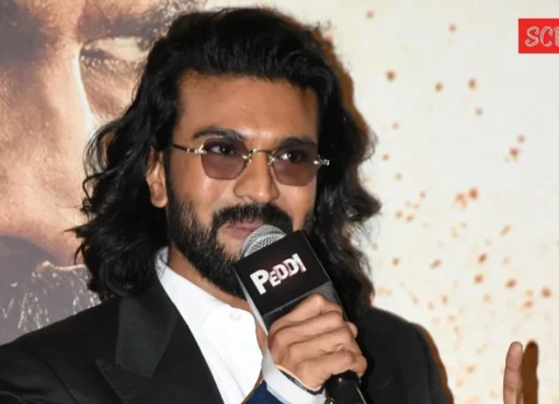 Ram Charan smiling, possibly at a film event.