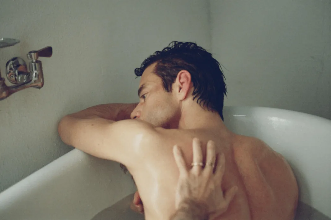Rami Malek in a movie still, looking thoughtful and intense.