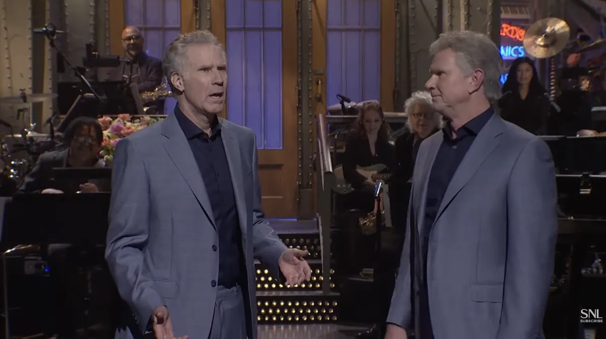Chad Smith and Will Ferrell standing together looking like identical twins on the Saturday Night Live stage.