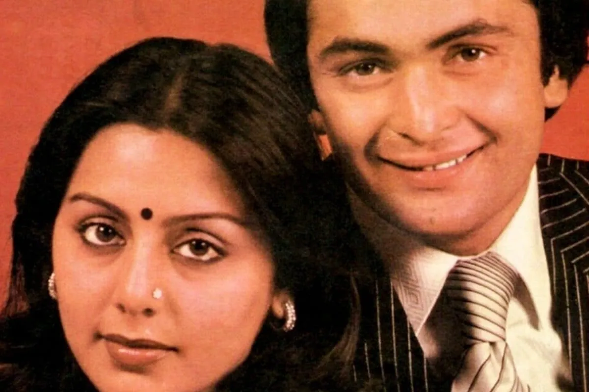 A vintage style photo of Neetu and Rishi Kapoor smiling together.
