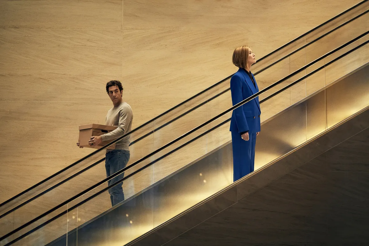 Sacha Baron Cohen and Rosamund Pike in a movie scene.