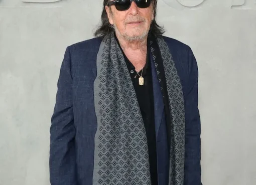 Al Pacino and Noor Alfallah posing for cameras at the Dior fashion show.
