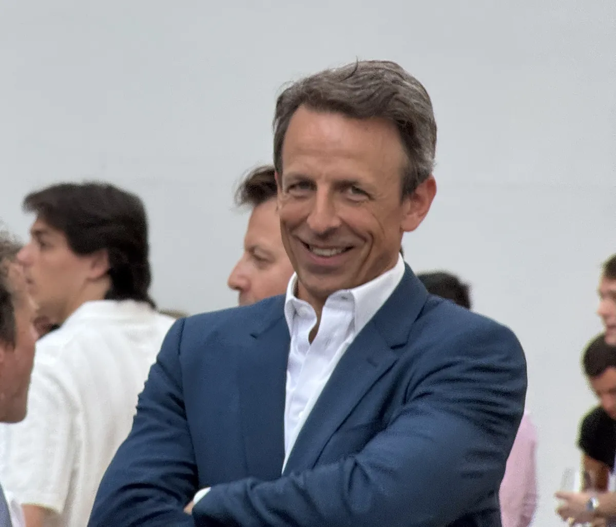 Seth Meyers looking thoughtful during an interview about Stephen Colbert