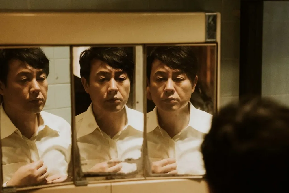 A shiny golden goblet award with a film reel and bright spotlight, representing the Shanghai International Film Festival.