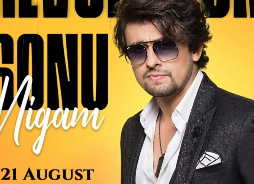 Sonu Nigam performing on stage with a colorful background.