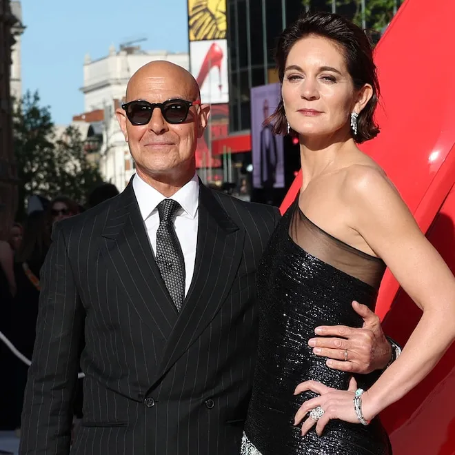 Stanley Tucci and Felicity Blunt smiling together.