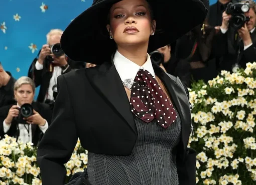 Rihanna on a red carpet at the Met Gala, wearing a dramatic, visually striking outfit.