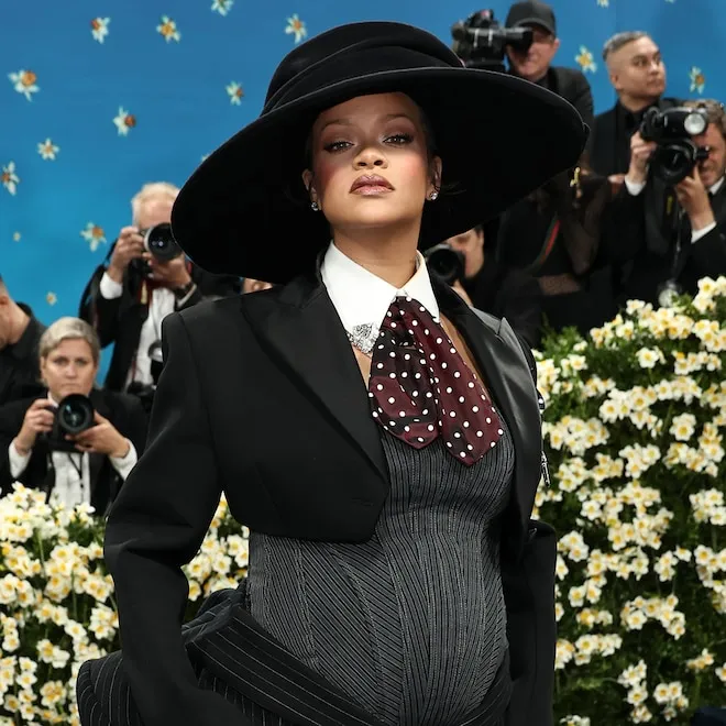 Rihanna on a red carpet at the Met Gala, wearing a dramatic, visually striking outfit.