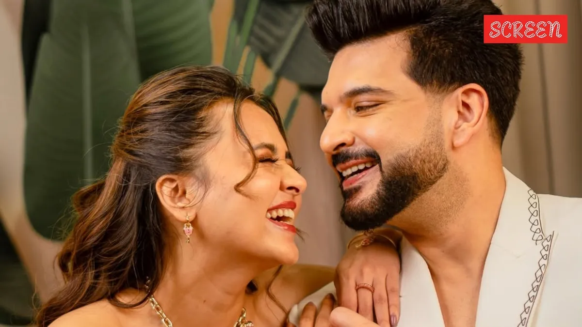 Tejasswi Prakash and Karan Kundrra smiling together at an event
