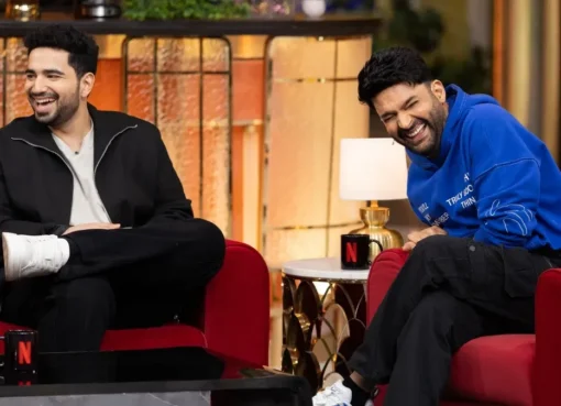 Samay Raina, BeerBiceps, and Kapil Sharma smiling and laughing on the set of The Great Indian Kapil Show.