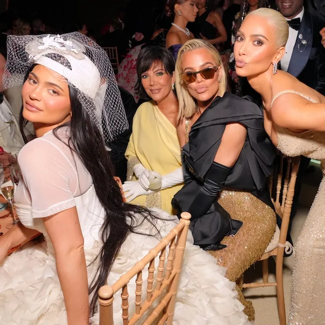 Rihanna and Kylie Jenner with their mothers, possibly celebrating a special occasion with extravagant gifts.