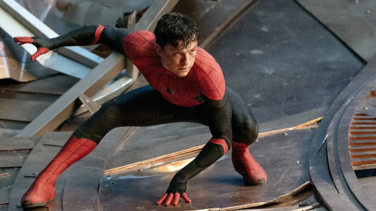 Tom Holland smiling, perhaps looking thoughtful about the future of Spider-Man.