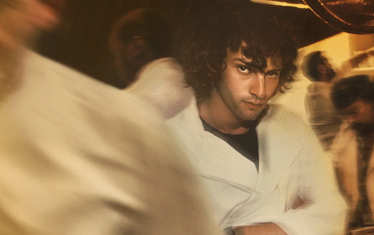 Dominic Sessa portrays a young Anthony Bourdain in a kitchen, looking determined.