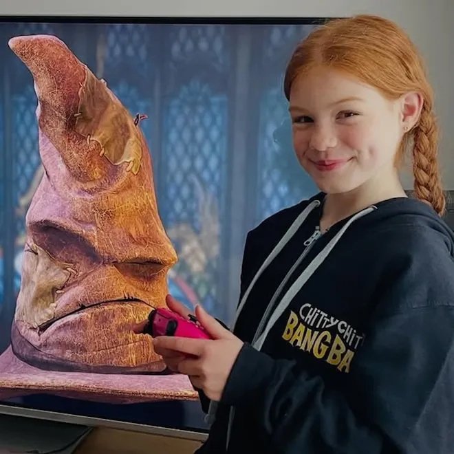 Gracie Cochrane as Ginny Weasley in a Hogwarts setting.