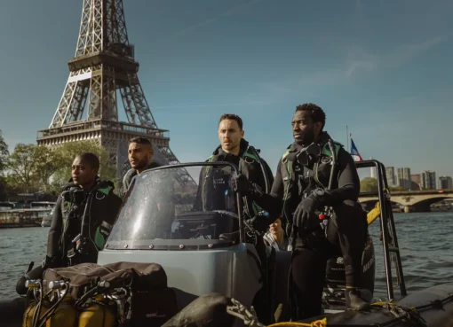A promotional image showing a shark's fin emerging from city waters, with the Eiffel Tower in the background.