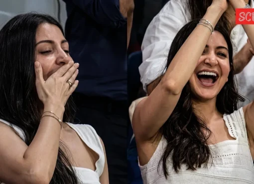Anushka Sharma blowing a flying kiss towards Virat Kohli in the stands.