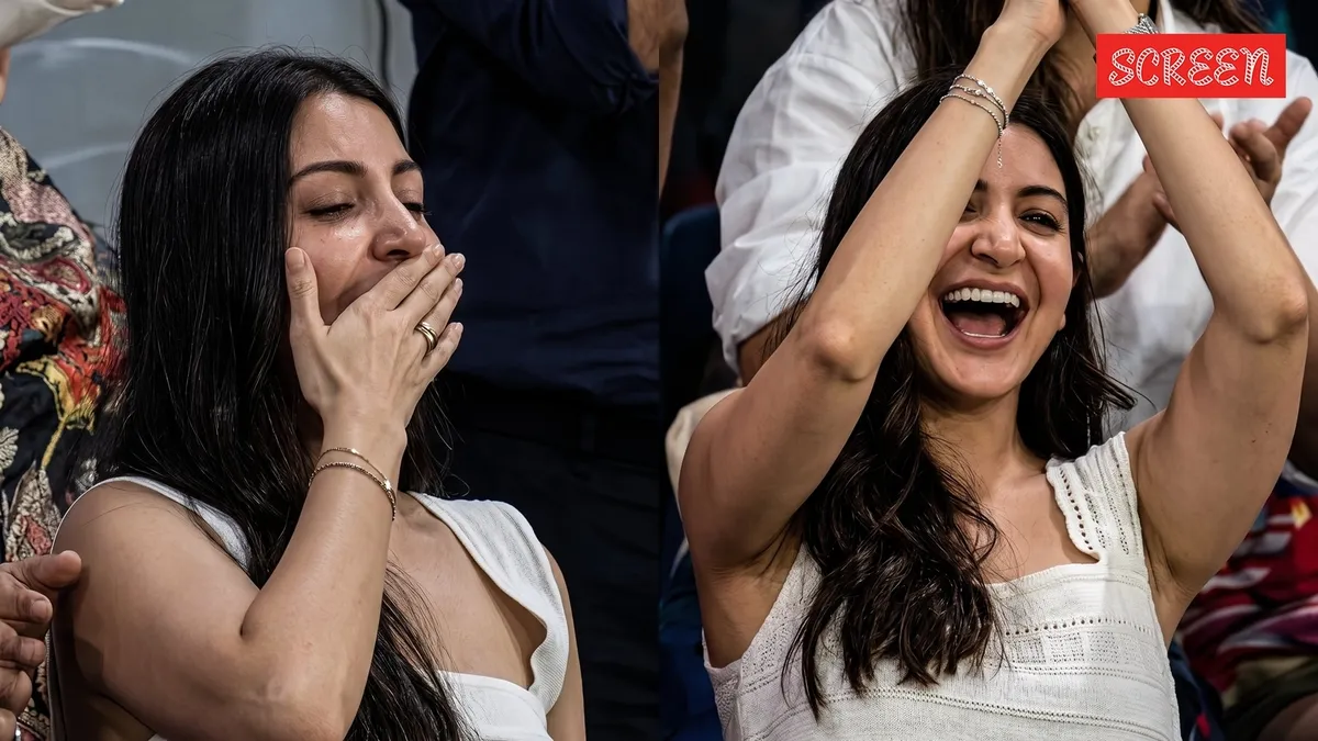 Anushka Sharma blowing a flying kiss towards Virat Kohli in the stands.
