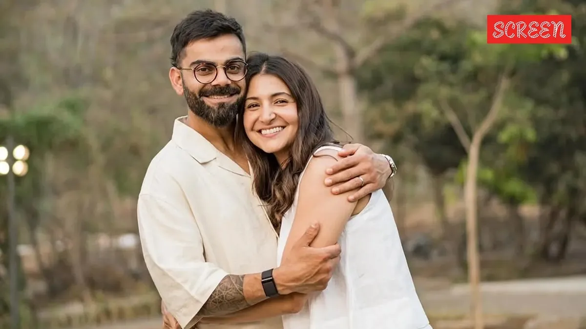 Virat Kohli and Anushka Sharma smiling together.