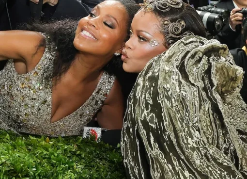 Rihanna smiling and talking to Sheinelle Jones on the Met Gala red carpet.