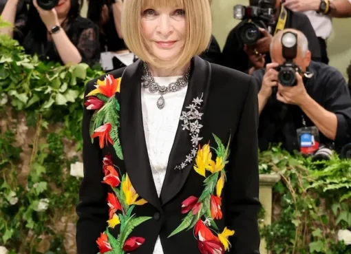 Stars walking the red carpet at the Met Gala in colorful outfits.