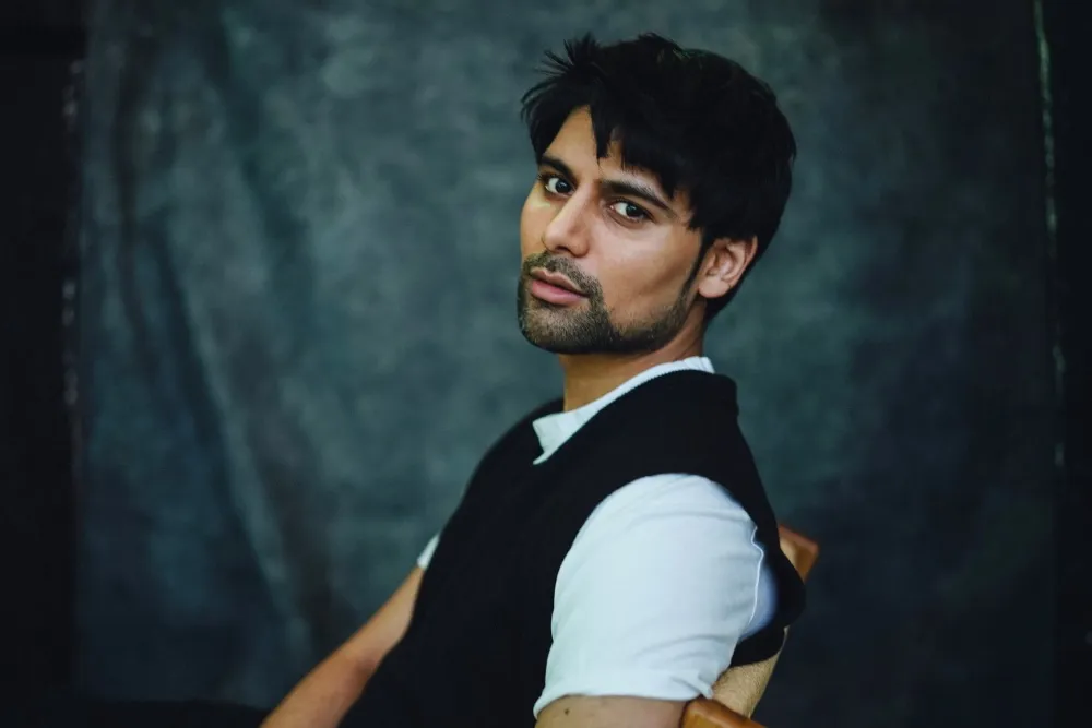 Antonio Aakeel smiling, perhaps on a film set.