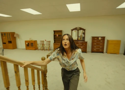 A movie poster for 'Backrooms' showing a person in a yellow, eerie, empty hallway.