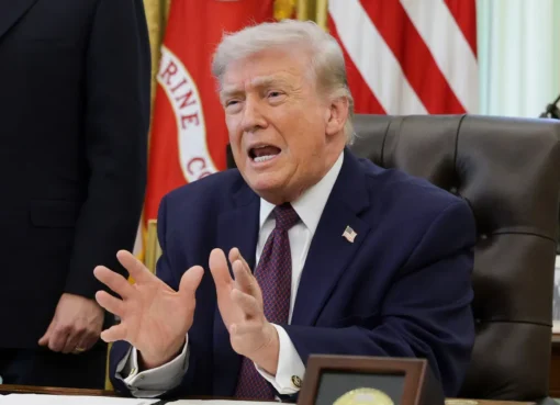 President Donald Trump signing a document, with an AI graphic overlay.