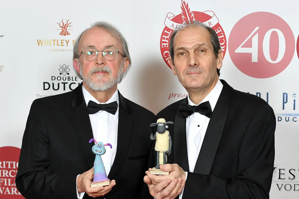 Peter Lord and David Sproxton, founders of Aardman Animations, smiling happily.