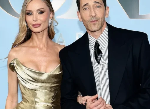 Adrien Brody and Georgina Chapman smiling together.