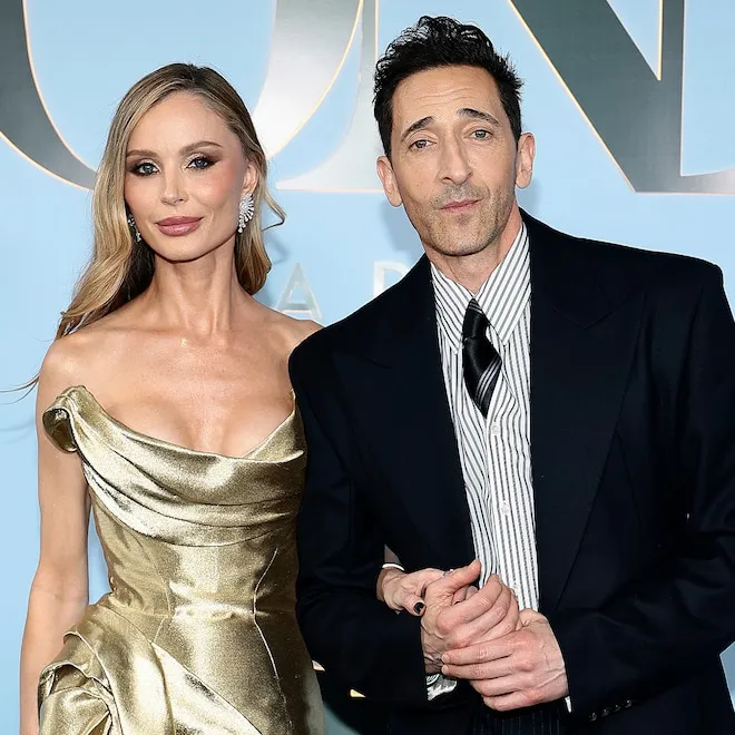 Adrien Brody and Georgina Chapman smiling together.