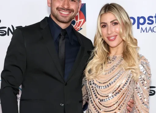 Alan Bersten and Emma Slater smiling and posing together.