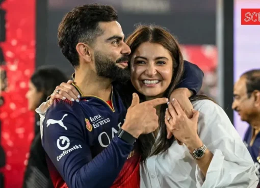 Anushka Sharma and Virat Kohli smiling together, with Mr Nags looking playfully annoyed in the background.