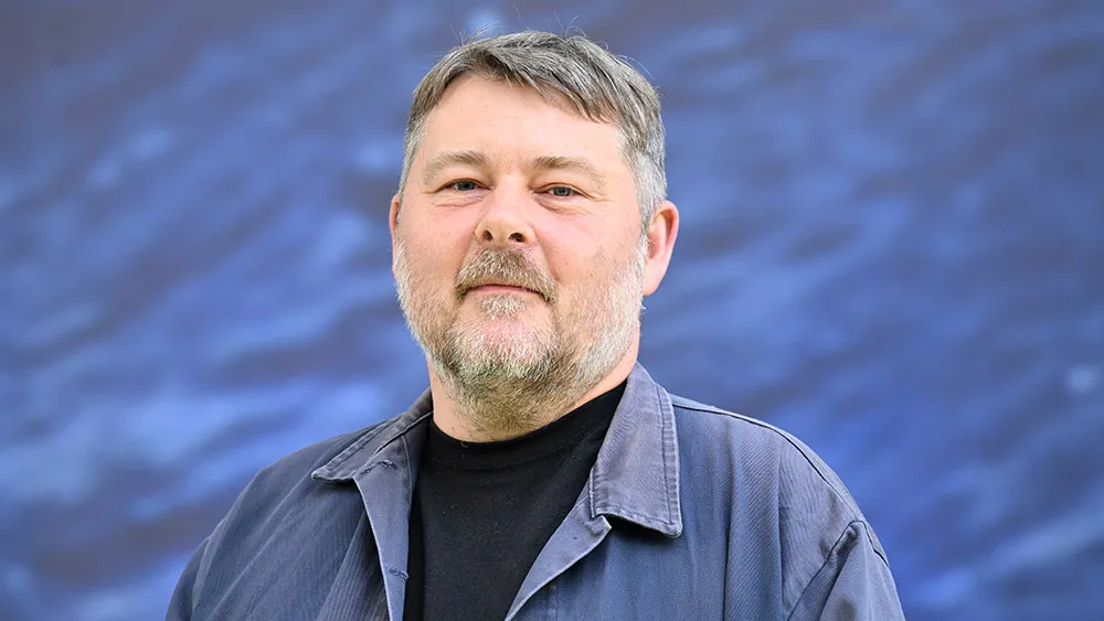 Ben Wheatley speaking enthusiastically at a film festival.