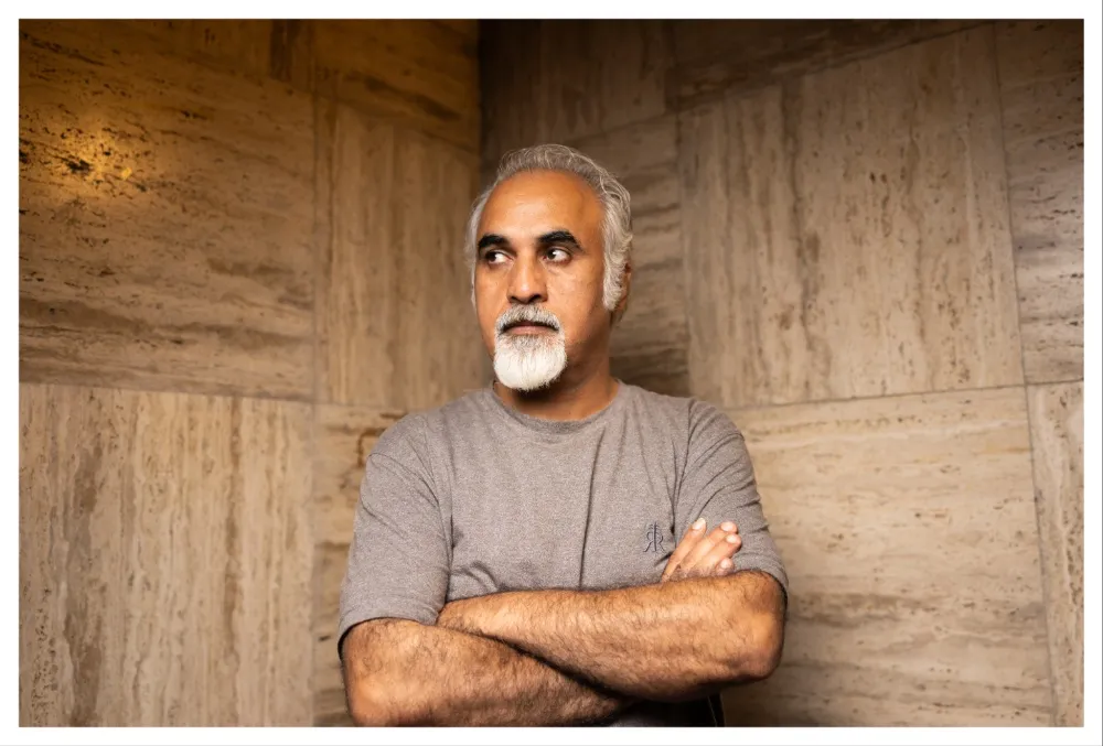 Portrait of director Nader Saivar looking thoughtful at a film festival.
