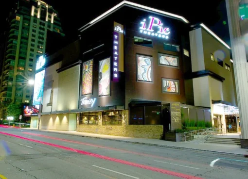 A stylish movie theater lobby with comfortable seating and a modern snack bar.