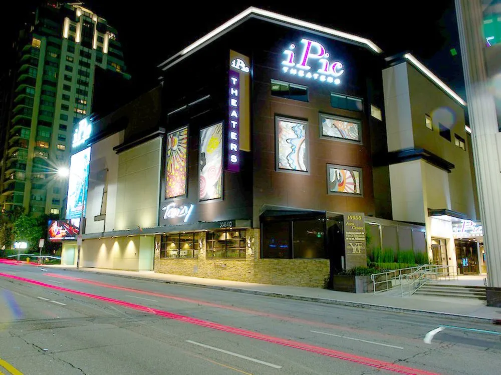 A stylish movie theater lobby with comfortable seating and a modern snack bar.