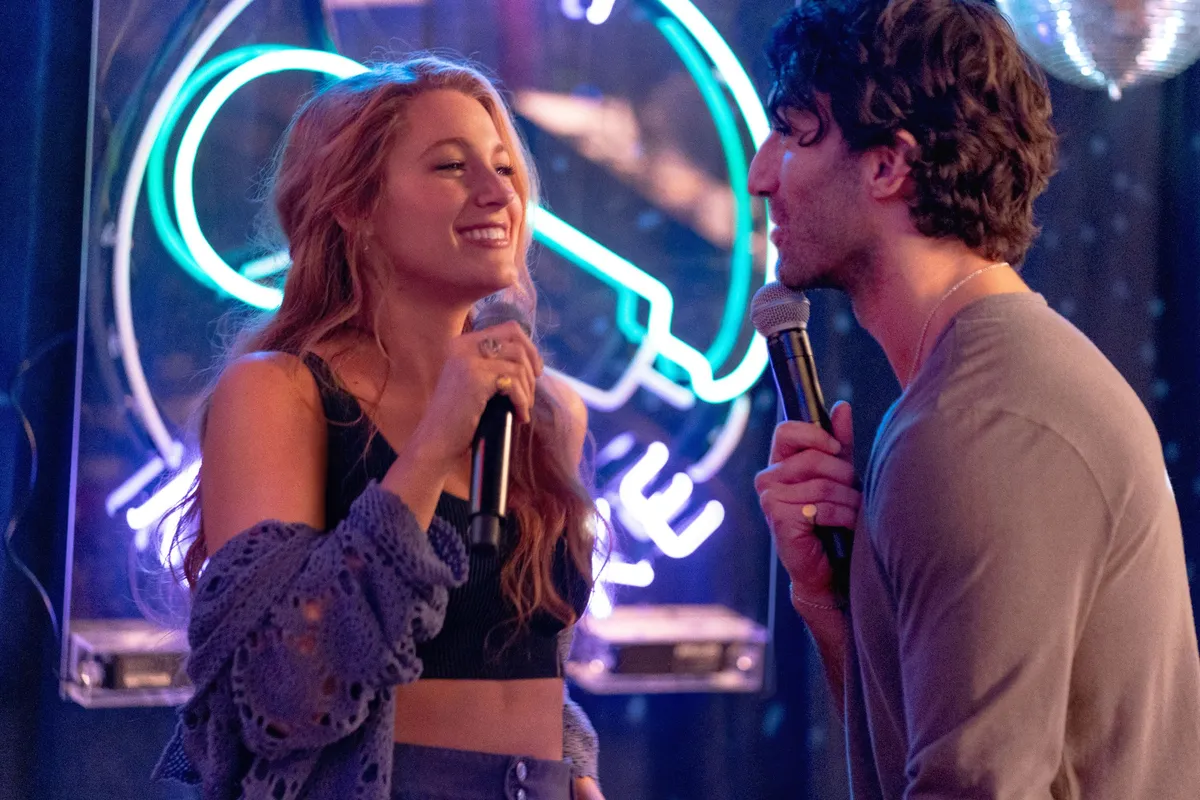 Blake Lively smiling brightly, celebrating a court victory.