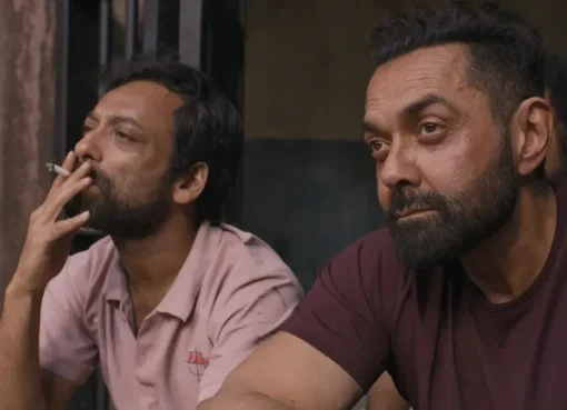 Bobby Deol looking serious in a movie still.
