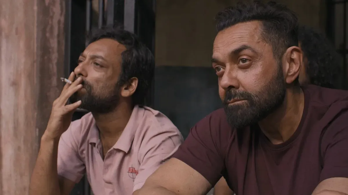 Bobby Deol looking serious in a movie still.