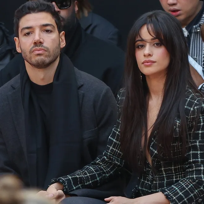 Camila Cabello looking thoughtful, with an implied background of a fading romance.