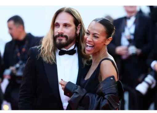 Marco Perego smiling on a red carpet at Cannes.