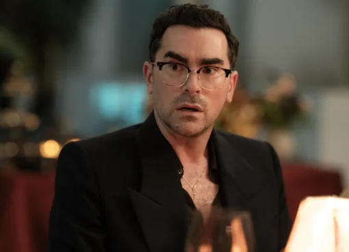 Dan Levy smiling, looking thoughtful.