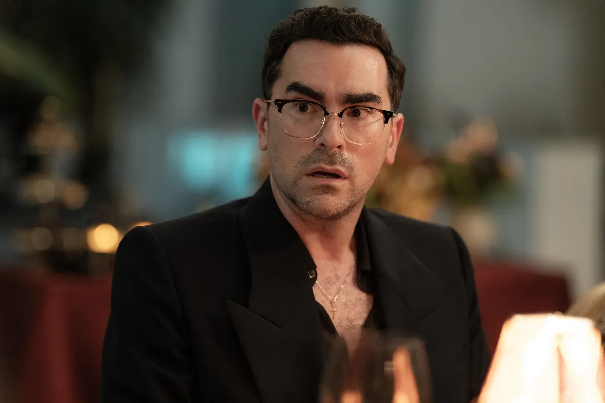 Dan Levy smiling, looking thoughtful.