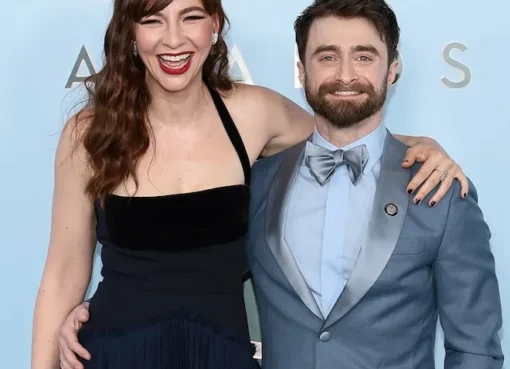Daniel Radcliffe smiling warmly on a stage, perhaps after a performance.