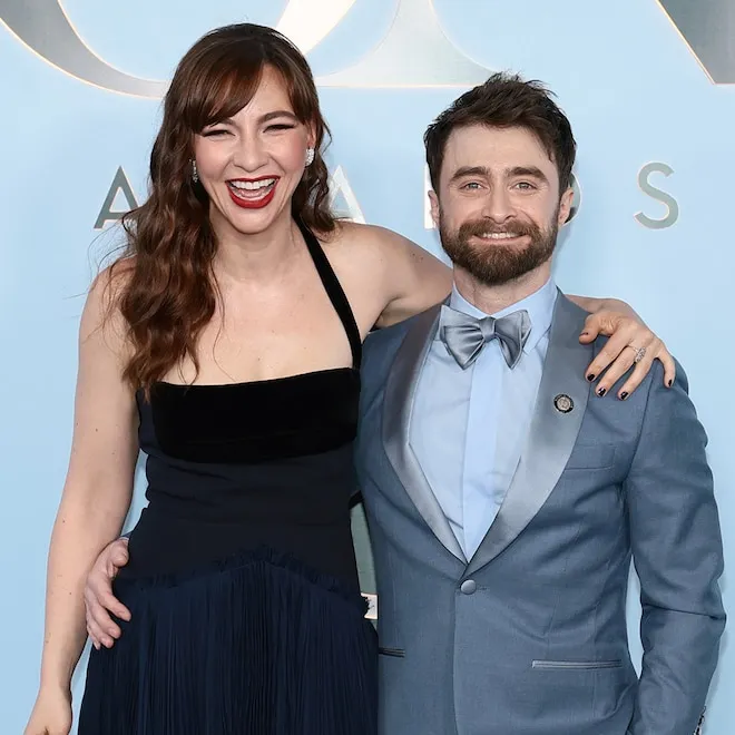 Daniel Radcliffe smiling warmly on a stage, perhaps after a performance.