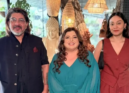 Delnaaz Irani smiling in a kitchen setting, next to Rajan Shahi and Ishika Shahi.