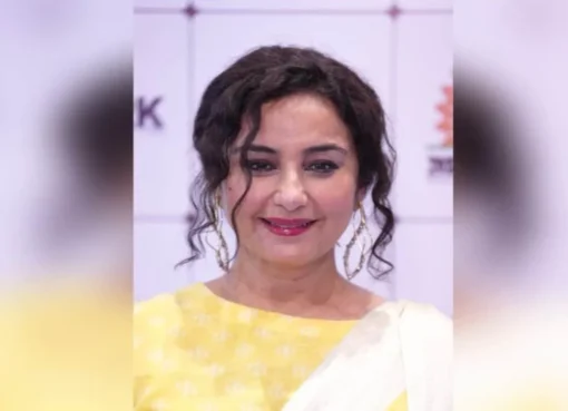 Divya Dutta smiling and holding a National Award.