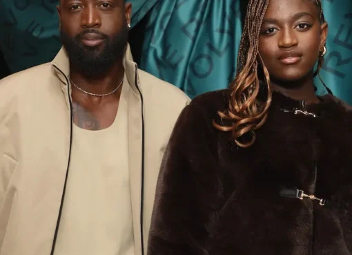 Dwyane Wade smiling warmly next to Zaya Wade, who is also smiling.