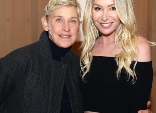 Ellen DeGeneres and Portia de Rossi hugging and kissing on a boat in Mallorca.